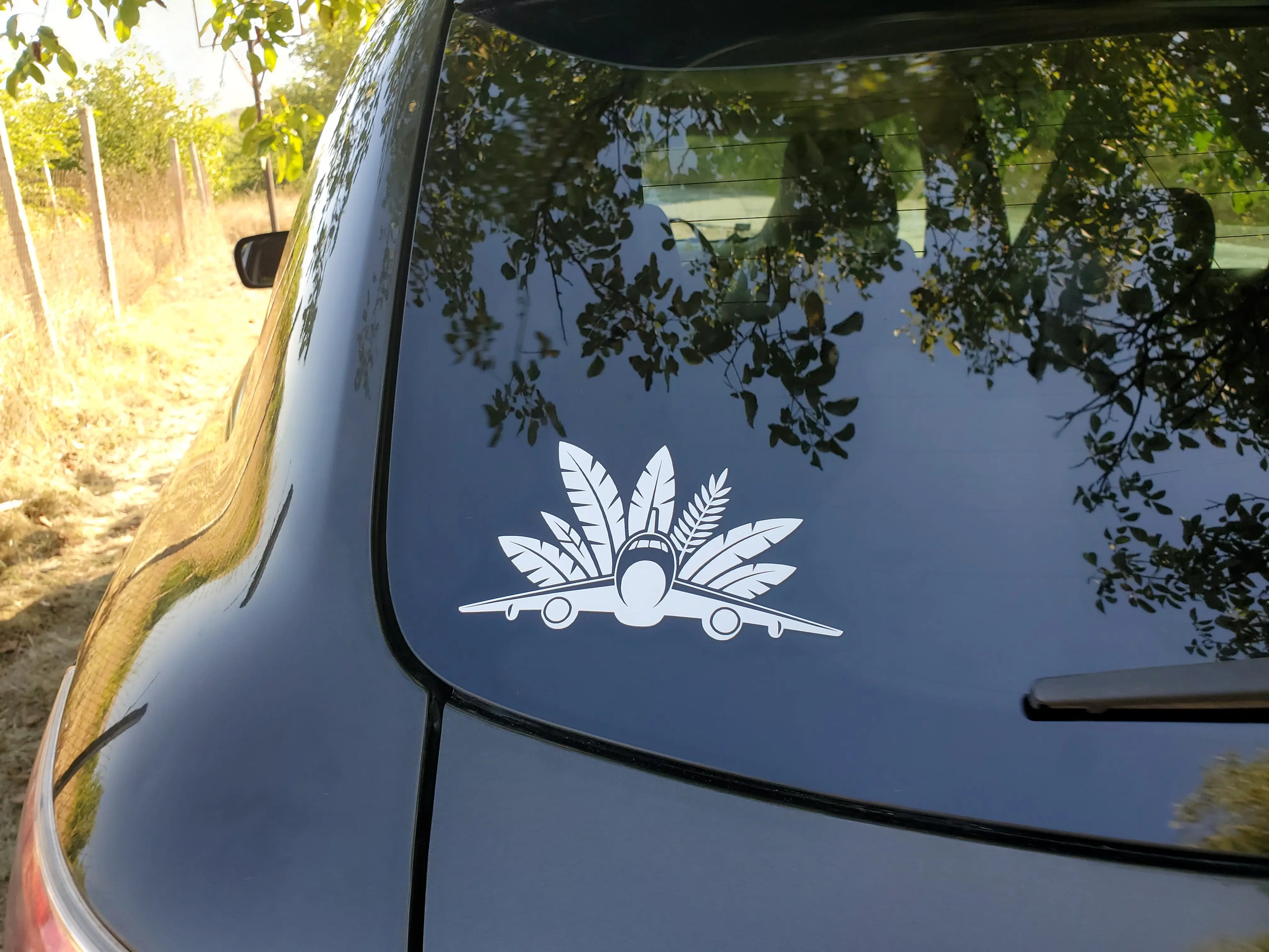 Minimal airplane vinyl decal with jet coming toward you and big palm leaves, a soft travel sticker accent for cars, luggage and airport coffee cups.
