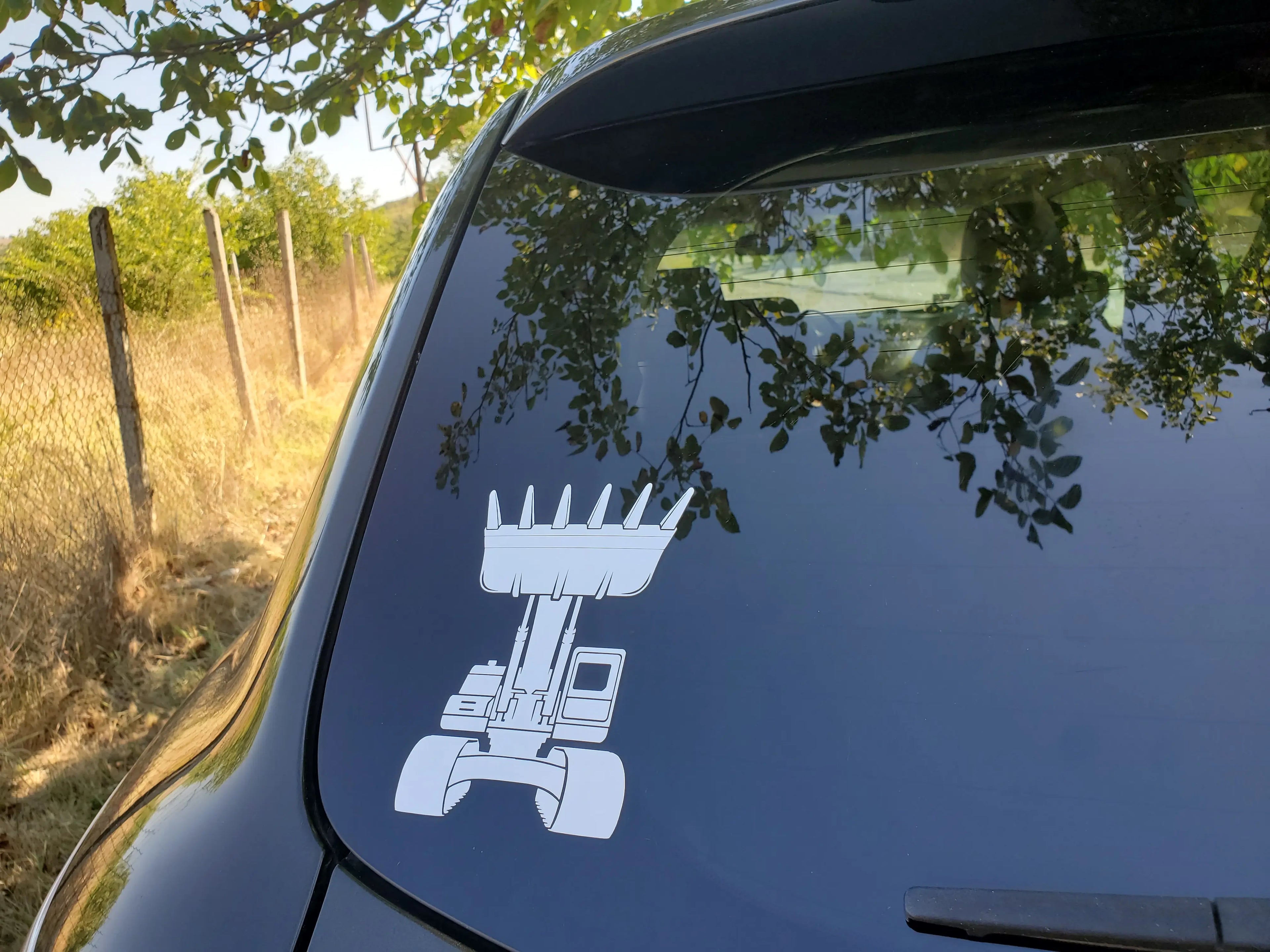 Minimal excavator vinyl decal featuring raised bucket with crown feel, a bold sticker accent for tool boxes, car windows and site folders.