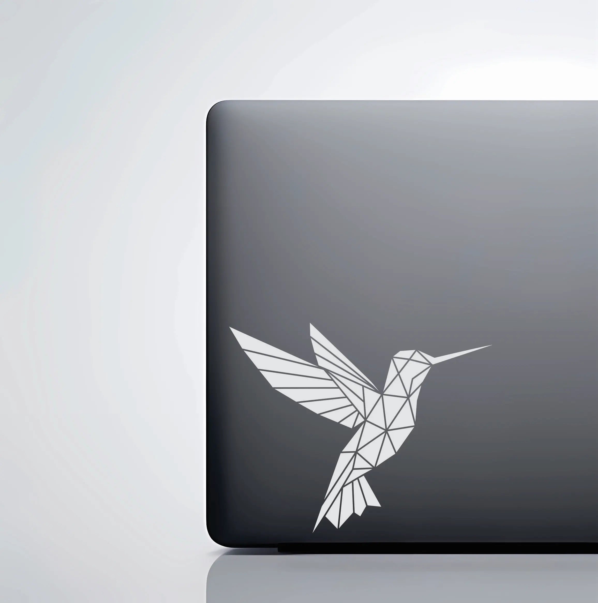 Geometric hummingbird vinyl decal made from sharp triangles, a modern bird sticker for cars, laptops and tumblers of minimal nature lovers.