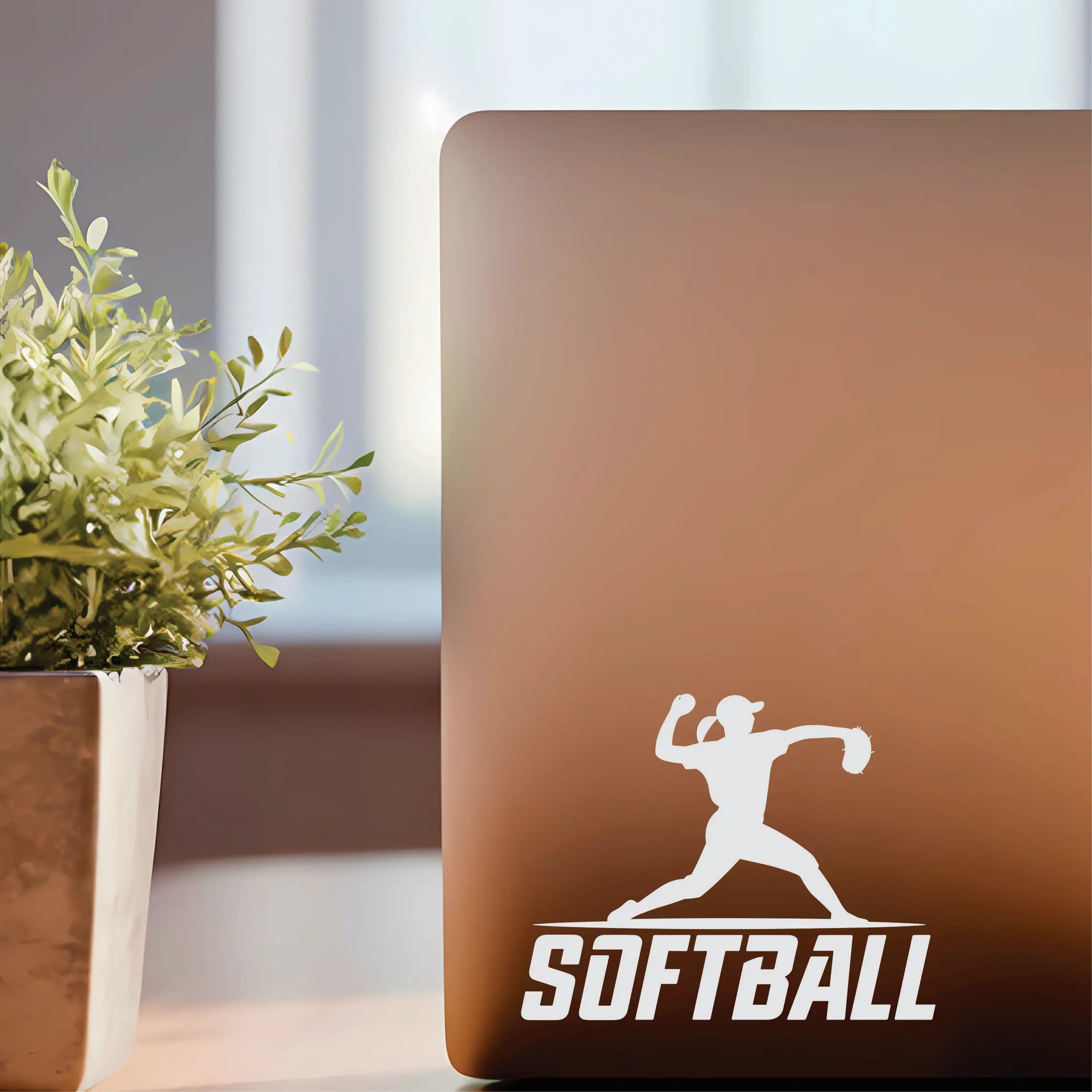 Softball player vinyl decal with a female silhouette throwing a ball while standing on “softball” text, a clean car and laptop sticker for players and coaches.