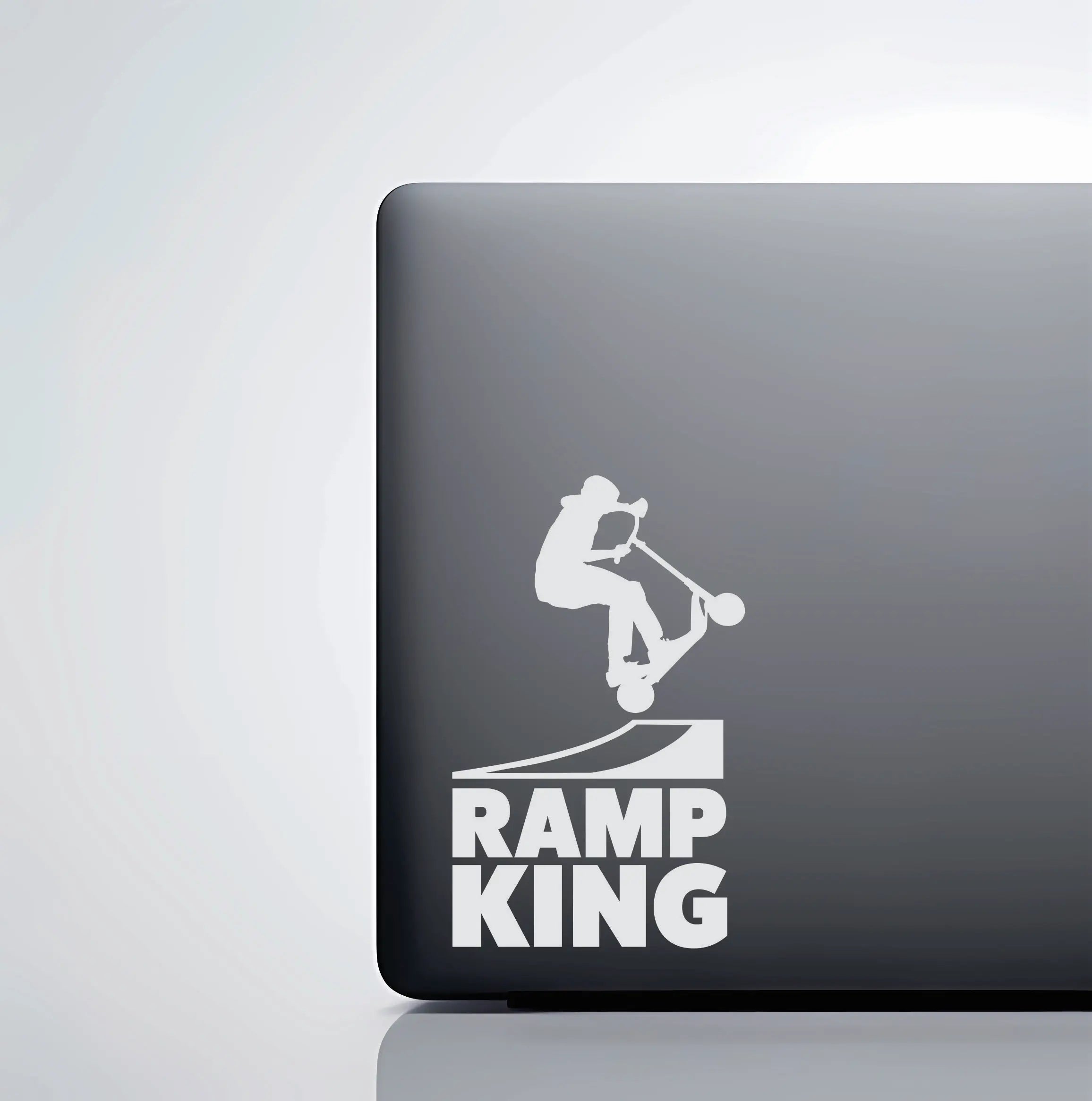 Ramp scooter vinyl decal shown on tumbler and laptop, a clean trick scooter sticker for kids and teens who ride skateparks after school.