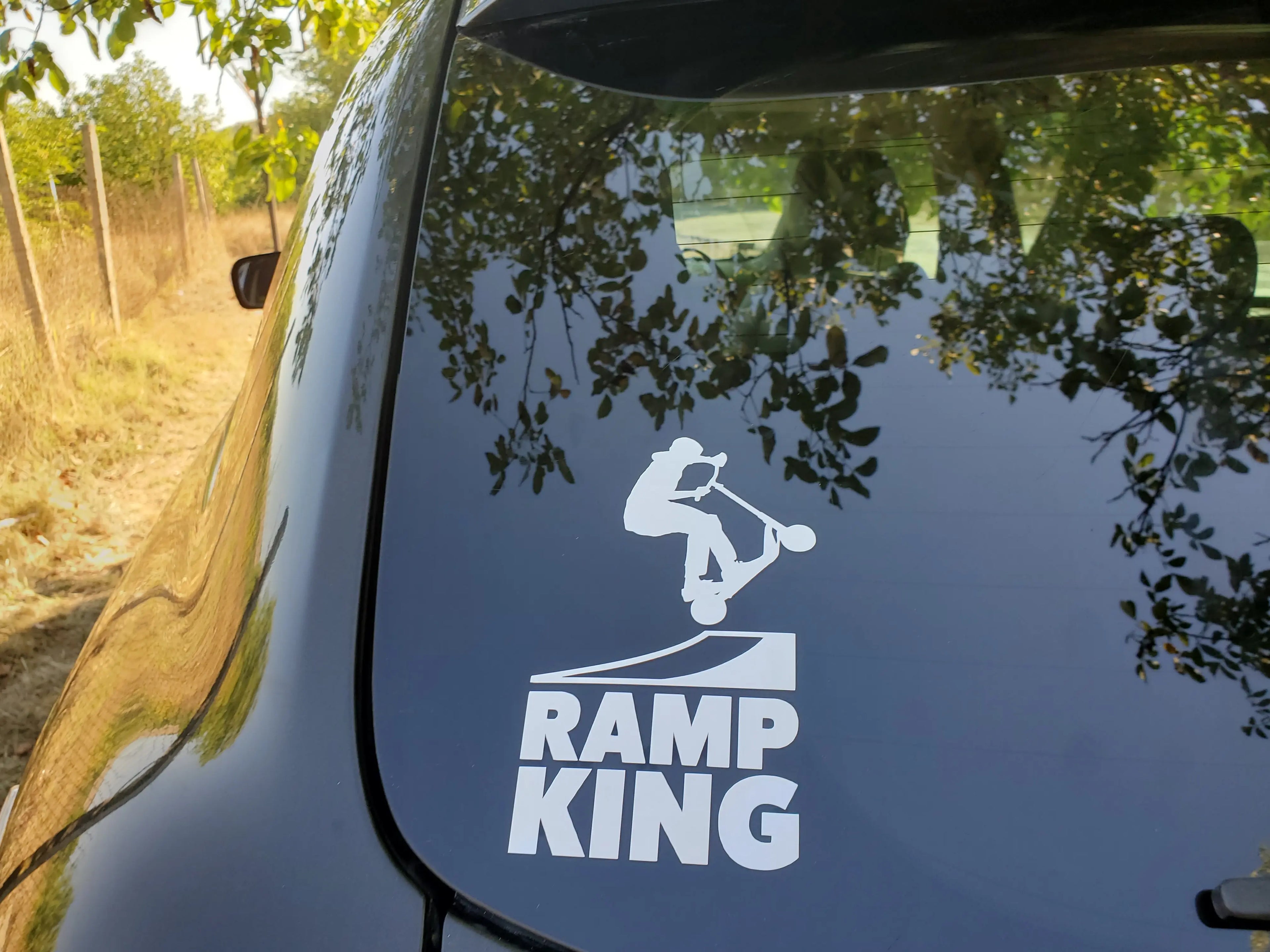 Minimal stunt scooter vinyl decal with jumping rider and ramp lettering, an energetic sticker accent for car windows, gear boxes and scooter bags.